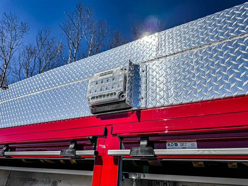 Upper side body close-up with diamond-plate trim and marker light.