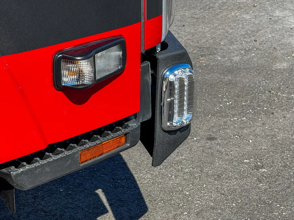 Front corner close-up showing side marker light and bumper edge.