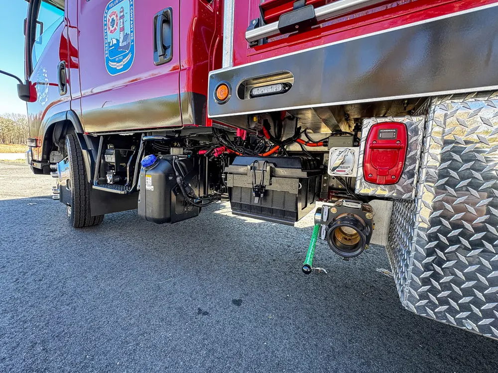 Rear underbody view showing axle area, frame, and tow connection.