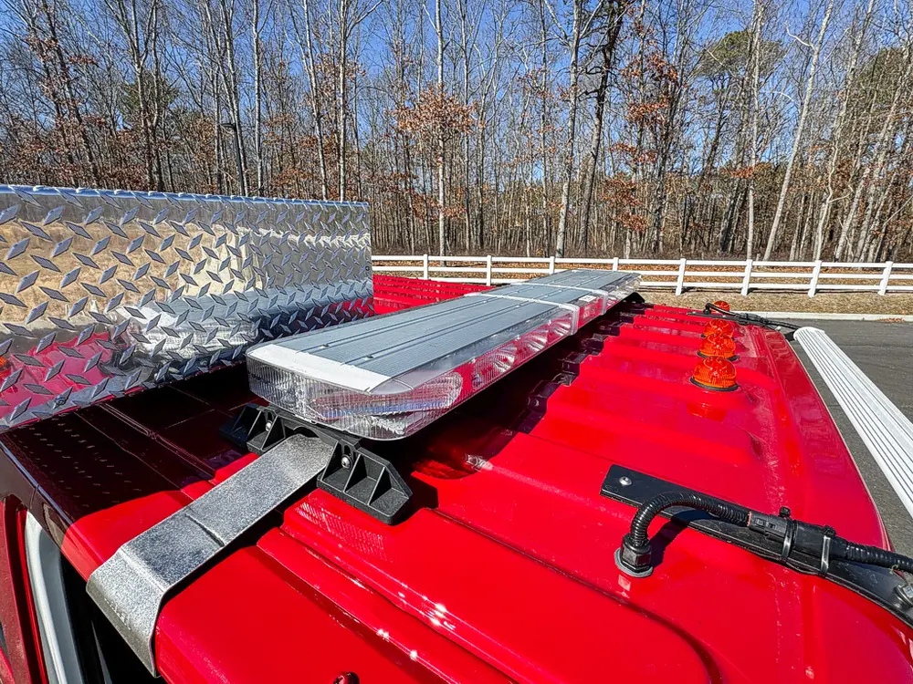 Top body rail close-up with folded ladder and red deck panel.