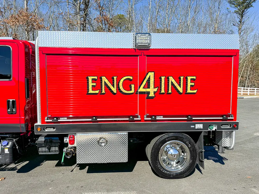 Mid-body right side view with large roll-up compartment panel.