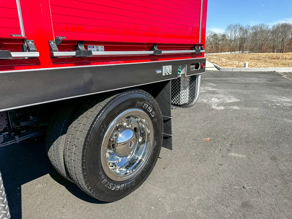 Rear wheel and lower side body trim close-up.