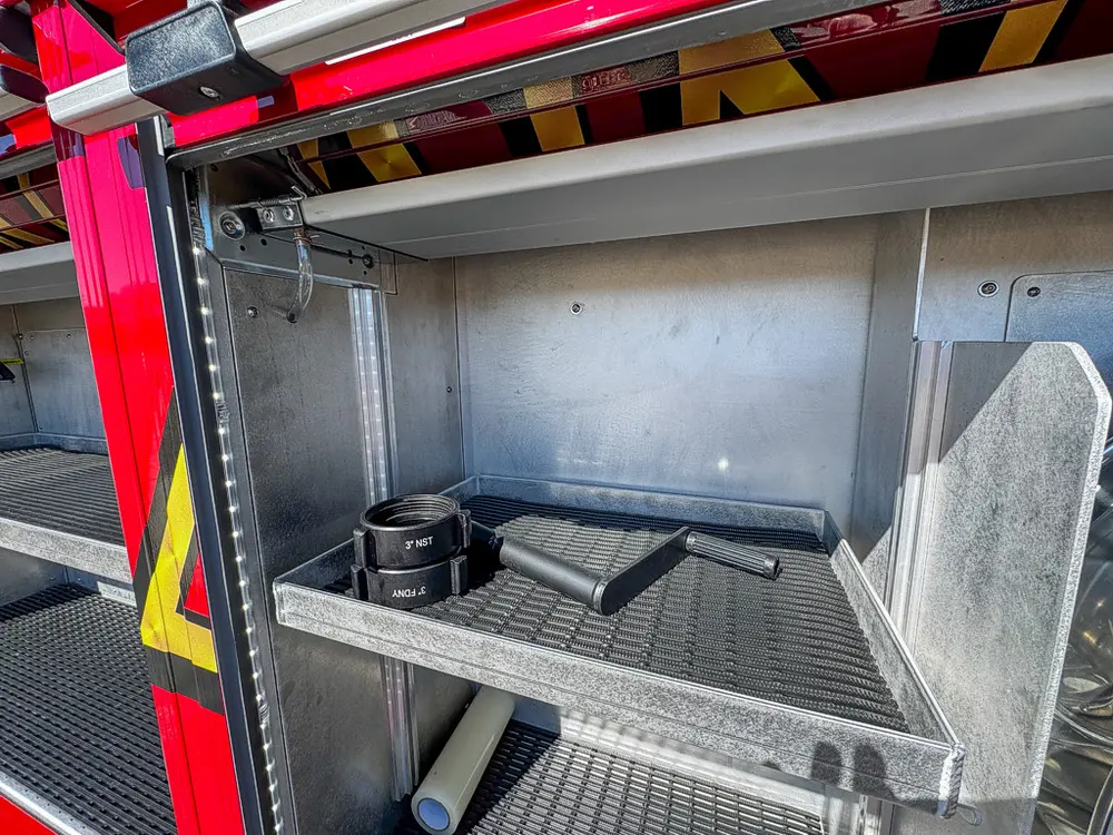 Open lower compartment with shelf and small loose items inside.