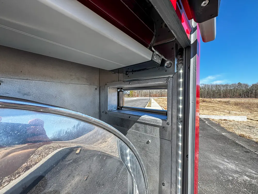 Compartment interior side-wall close-up with reflective metal finish.
