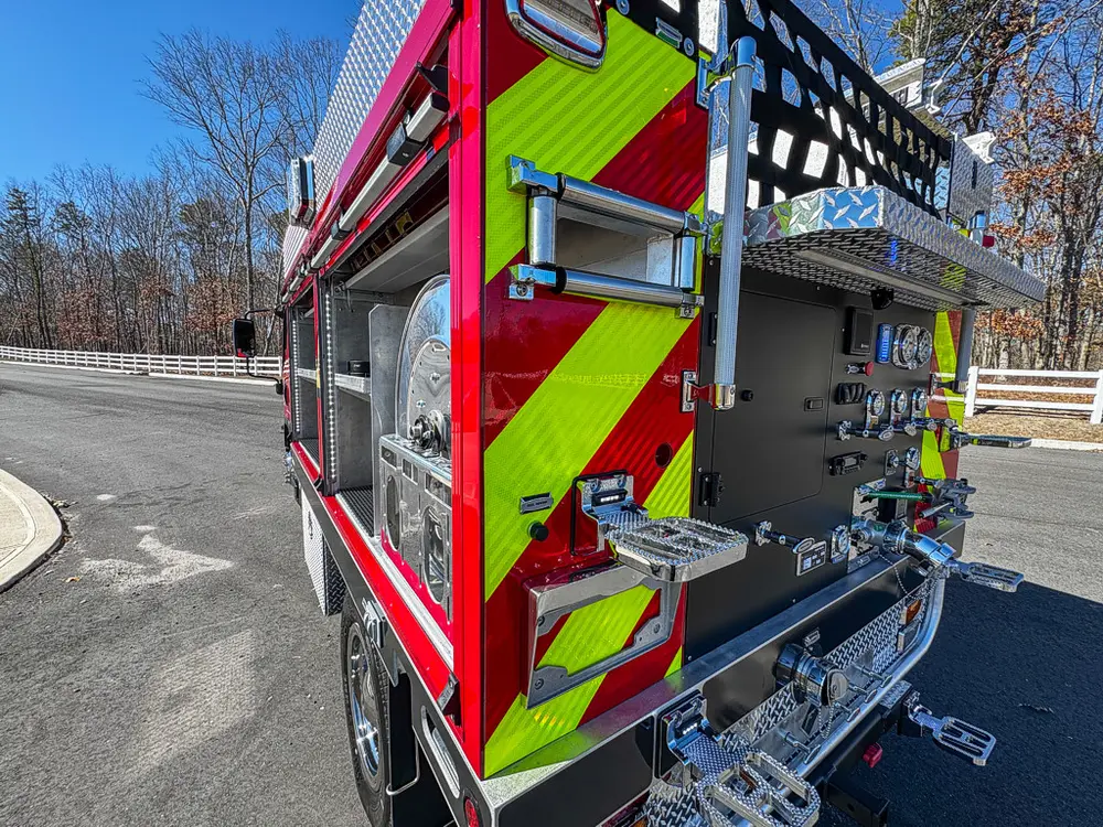 Rear-right three-quarter view with pump panel and chevron striping.