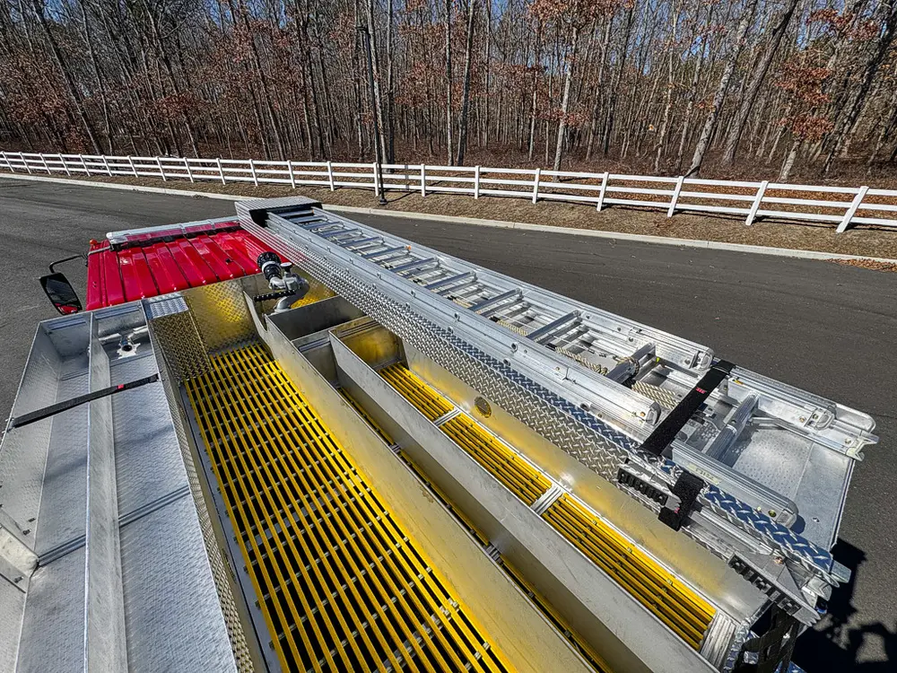 Top-deck view over yellow grated walkway and roof-mounted hardware.
