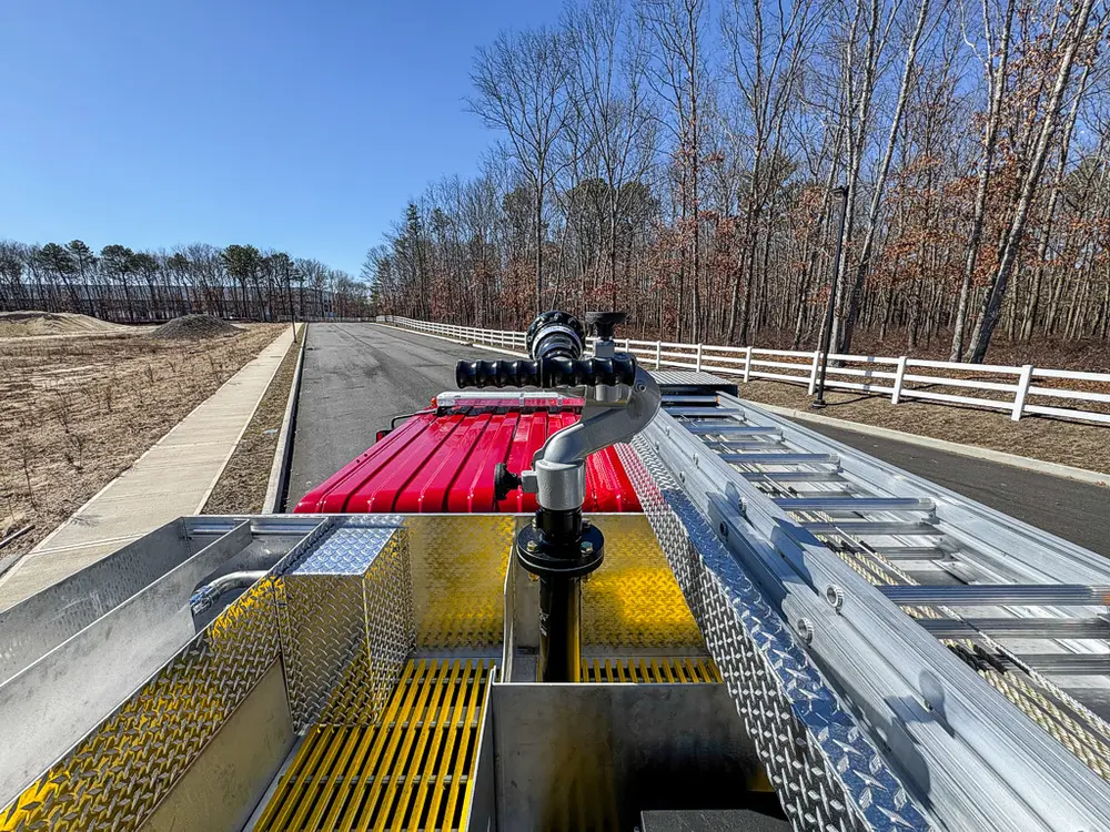 Forward top-deck view along the grated walkway toward the cab.