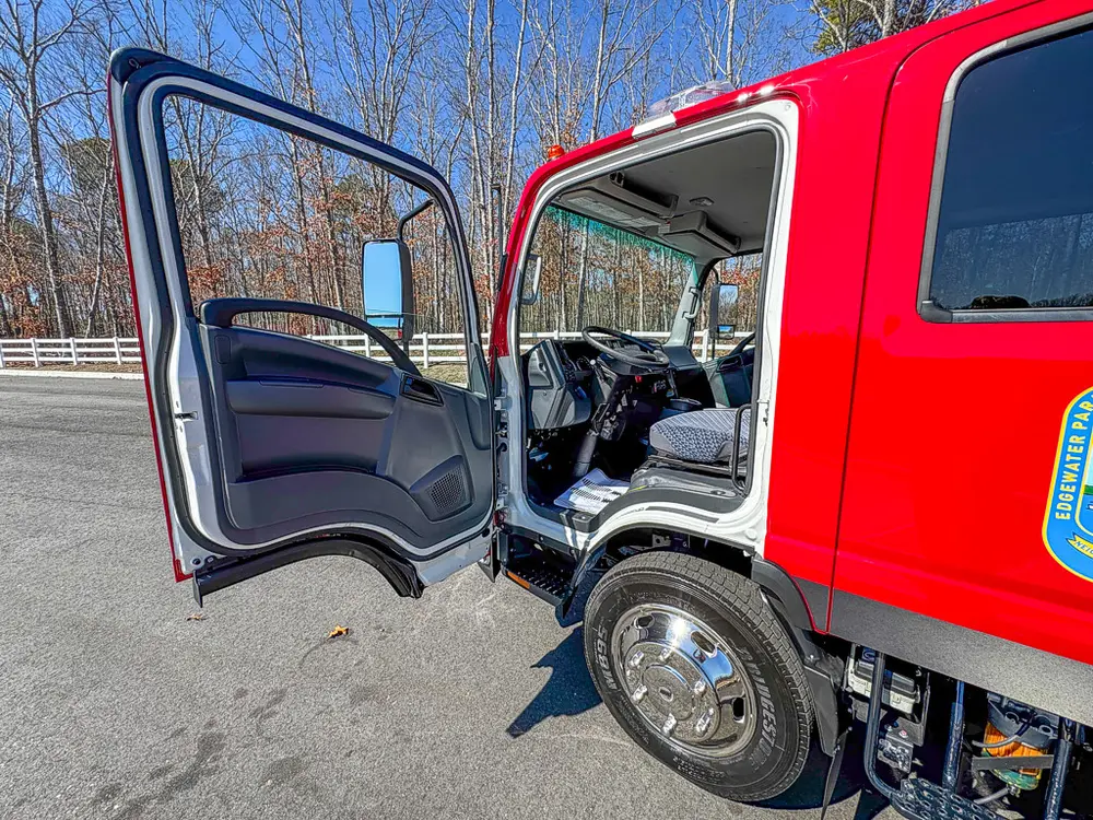 Open driver door exterior view showing front cab entry.