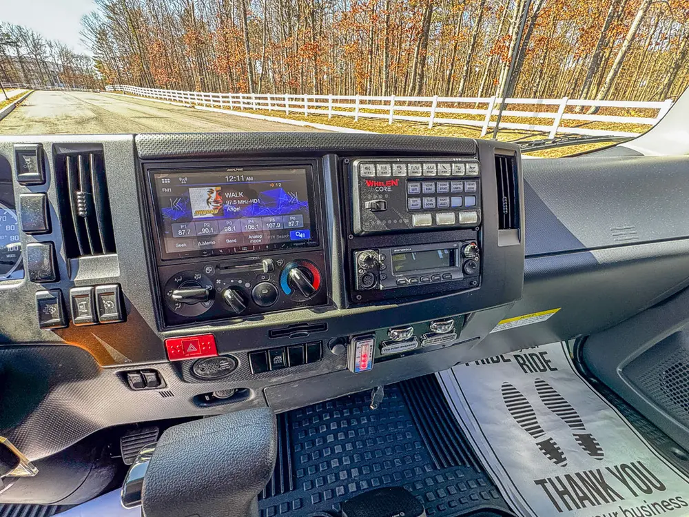 Dashboard center stack close-up with screens and control switches.
