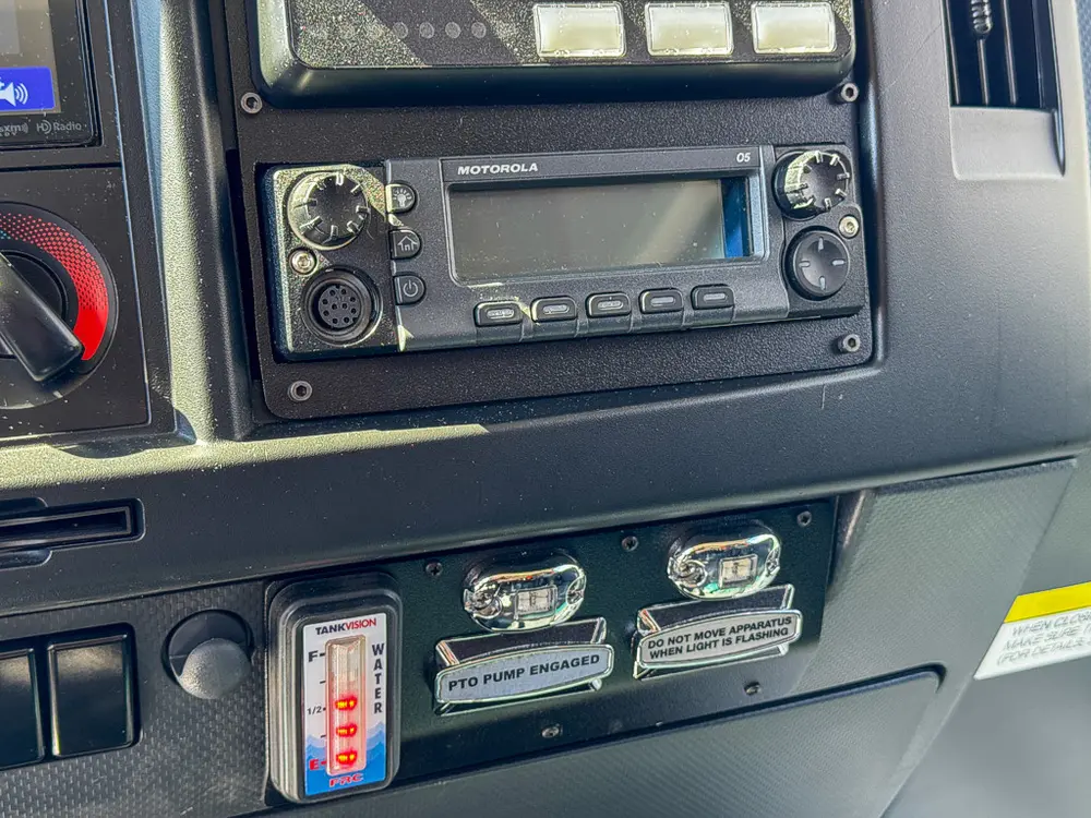 Passenger-side dash close-up with radio, controls, and accessory ports.