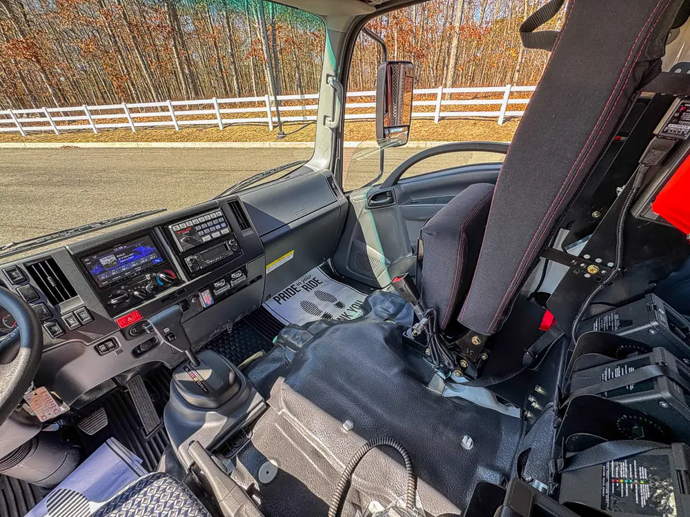 Front cabin view showing center console controls and seats.