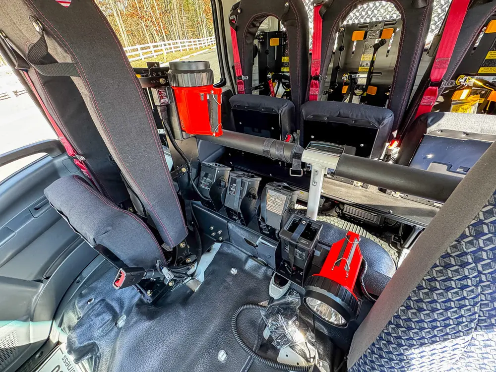 Rear seating and center aisle view with equipment mounted behind seats.
