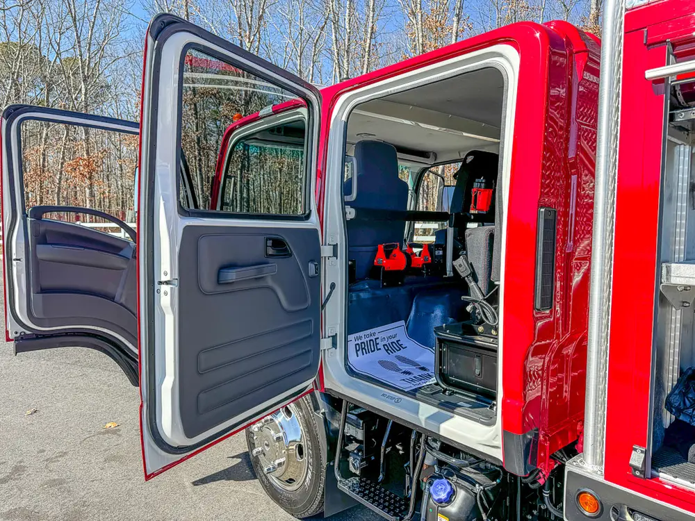 Open rear side door view showing bench area and interior layout.