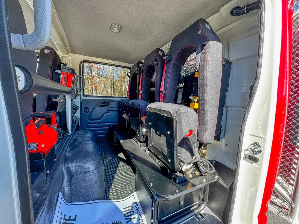 Rear seating area with center aisle and safety-seat backs visible.