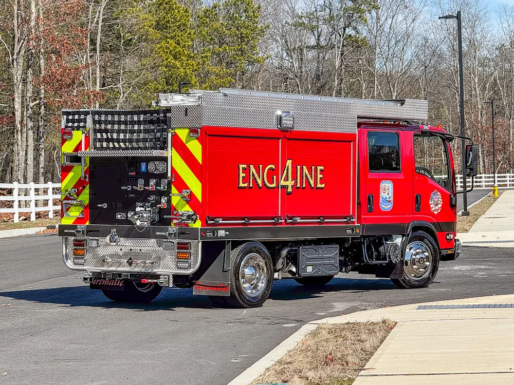 Rear-left three-quarter view showing pump controls and hosebed area.