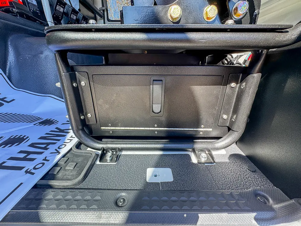 Open center floor storage compartment behind front seats.