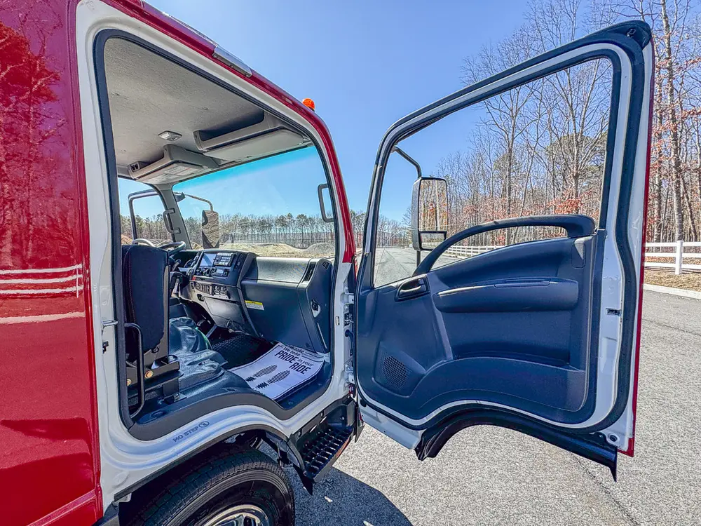 Open passenger door view with front seat and dashboard visible.