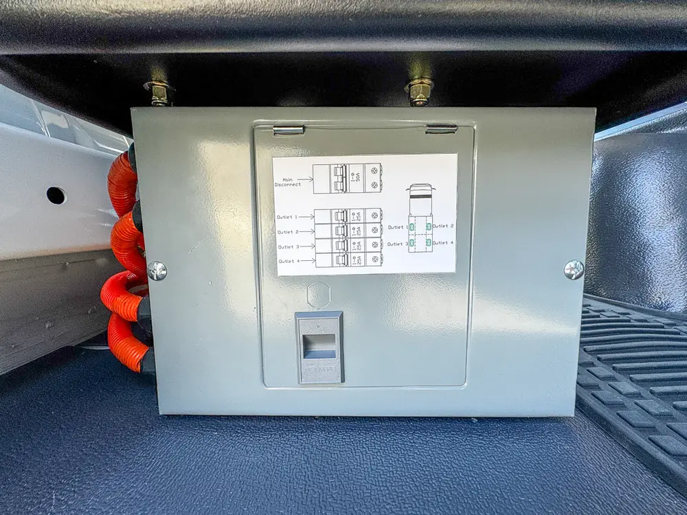 Close-up of mounted electrical breaker panel inside a compartment.