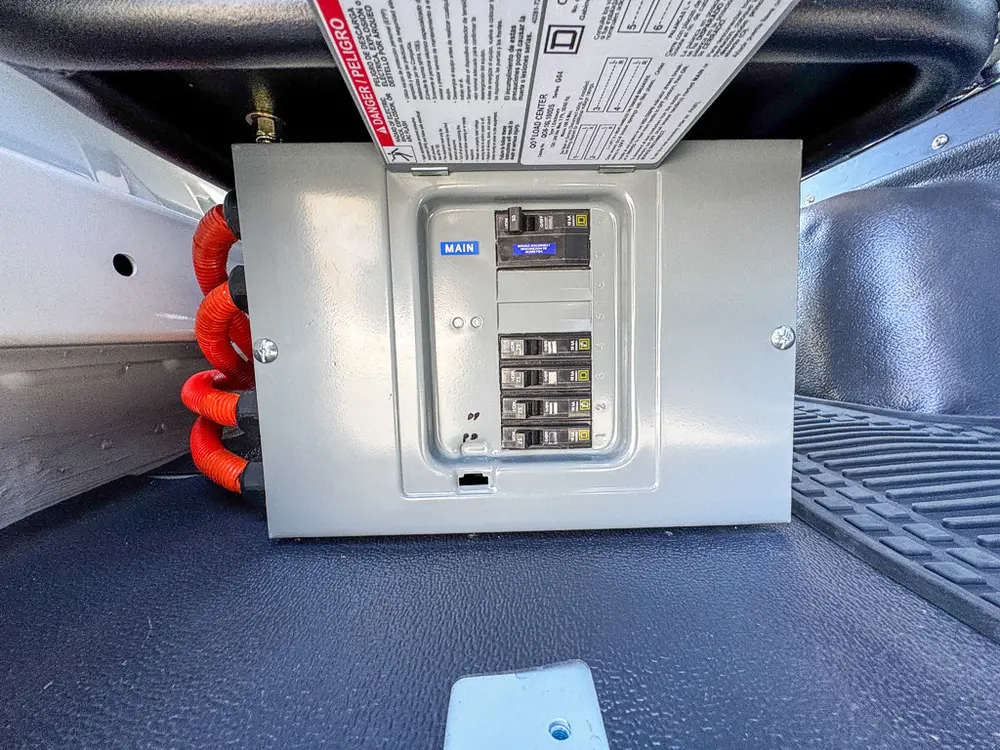 Close-up of electrical control panel with labeled breaker switches.