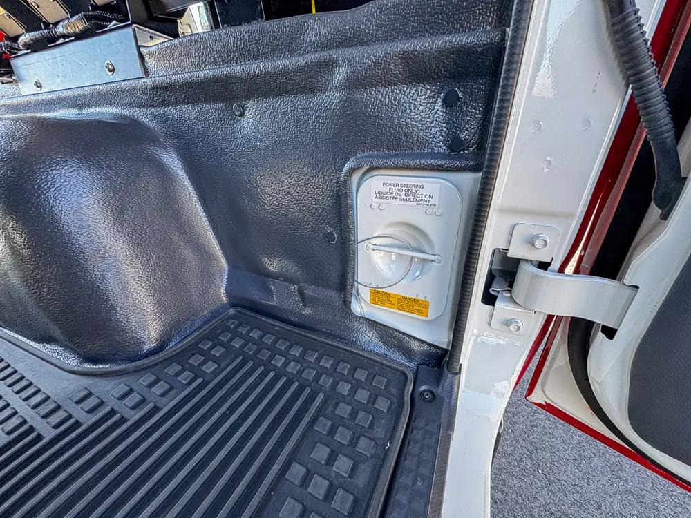 Interior side panel and seat-base area close-up in the rear cabin.