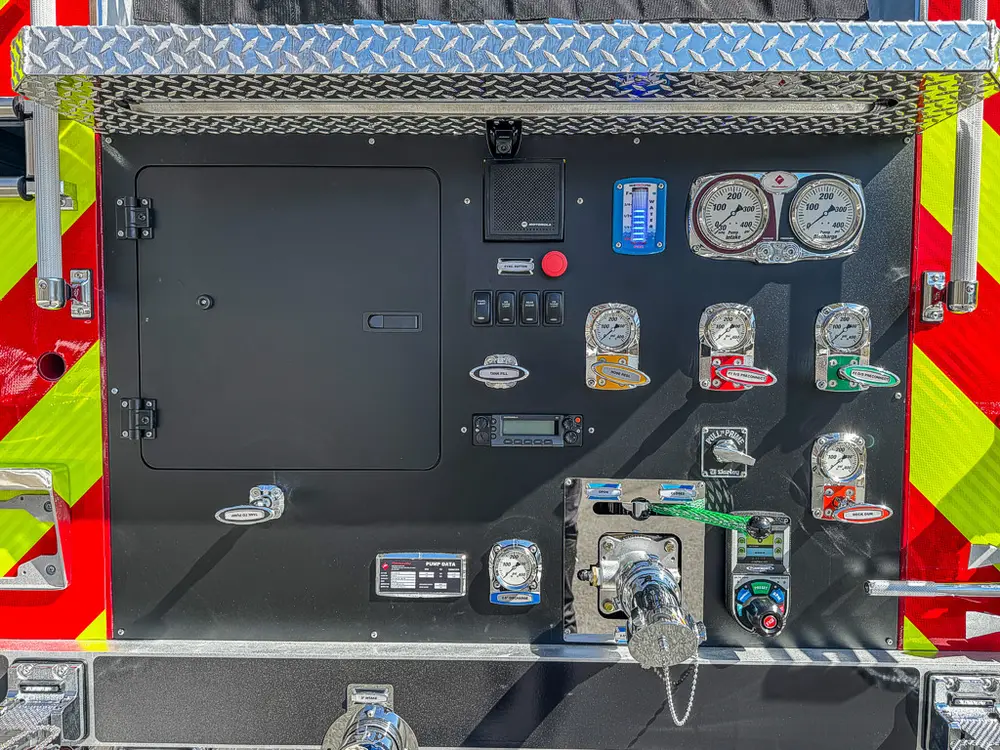 Rear pump control panel close-up with gauges and valves.