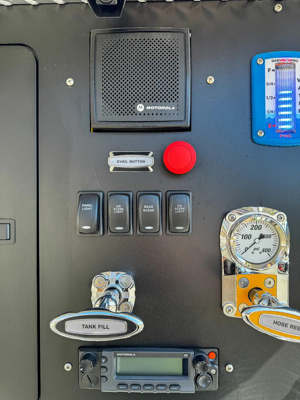 Left side of pump panel close-up with switches, gauges, and indicator lights.