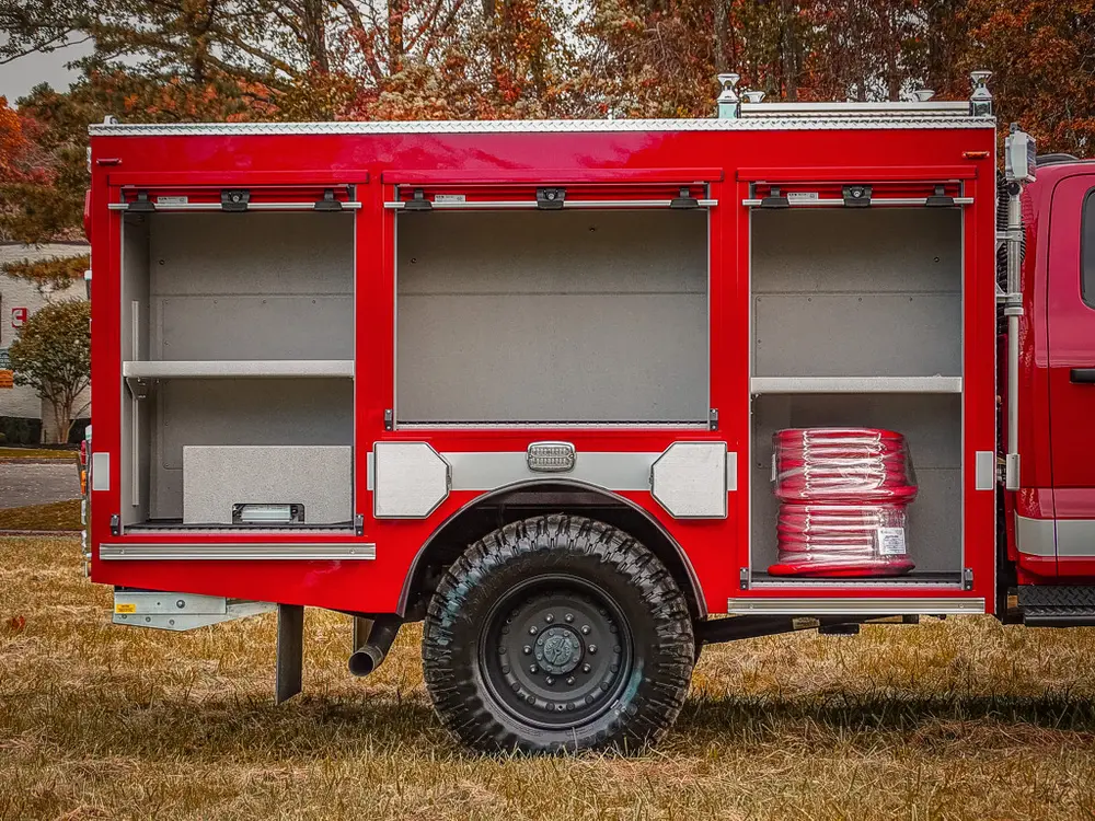 Close-up of open side compartments and rear wheel area.