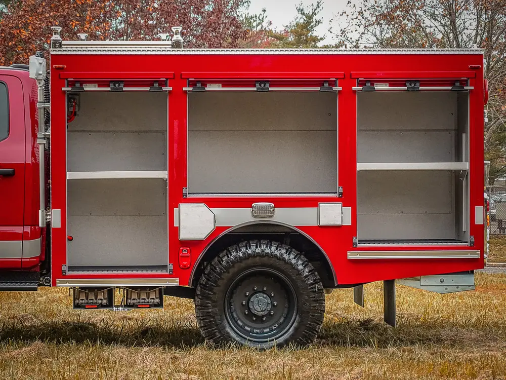 Mid-body compartment close-up with shelves and roll-up doors.