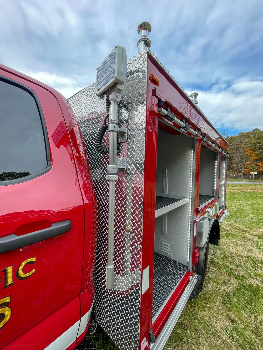 Narrow compartment bay beside cab with vertical shelf layout.