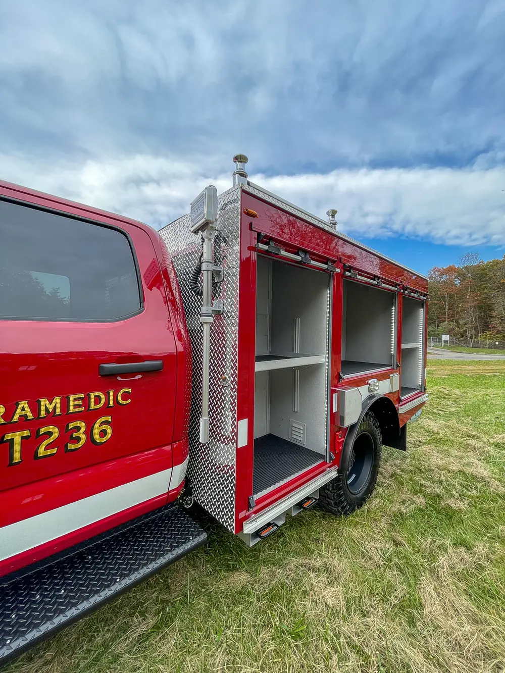 Passenger-side rear compartment open with long empty shelves.