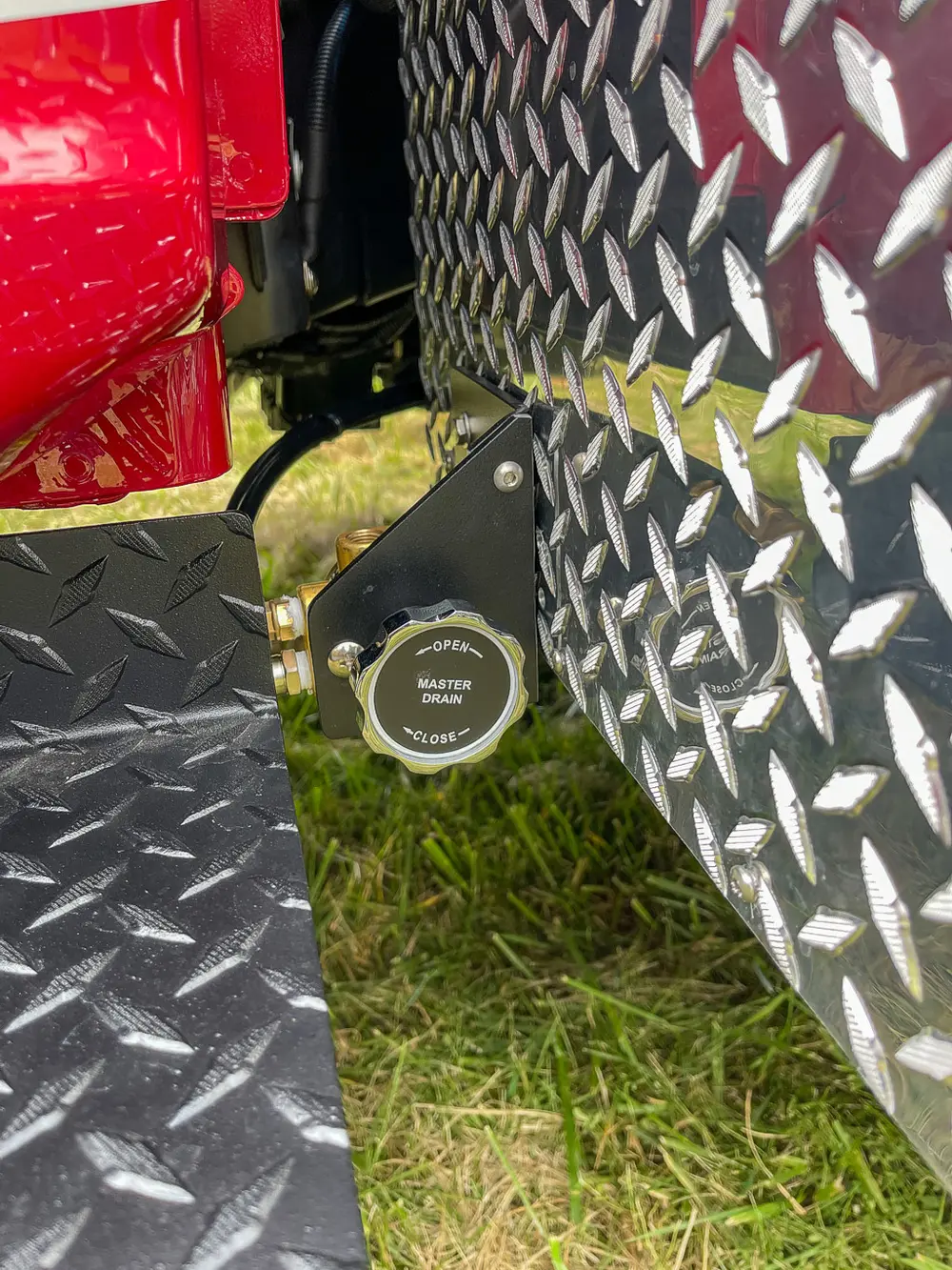Close-up of external power inlet on diamond-plate panel.