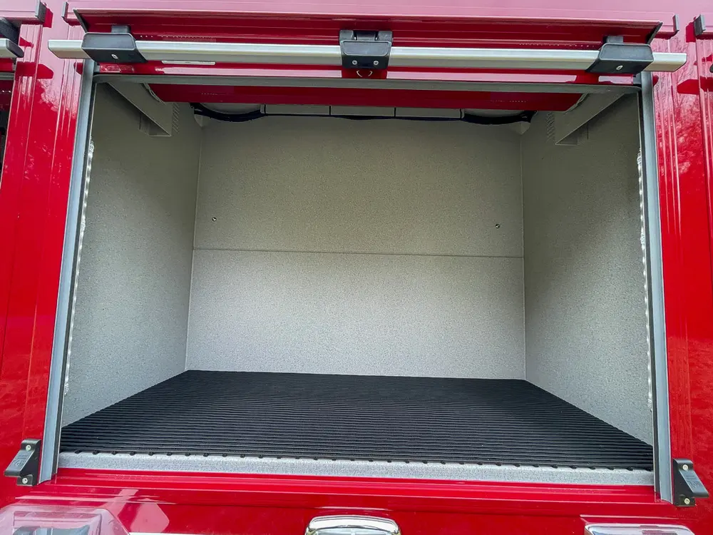 Wide open rear side compartment with clean interior panels.