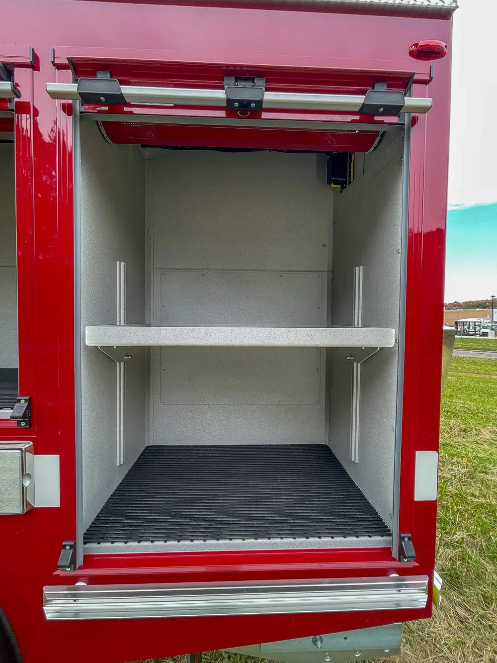 Open vertical compartment with fixed center shelf.