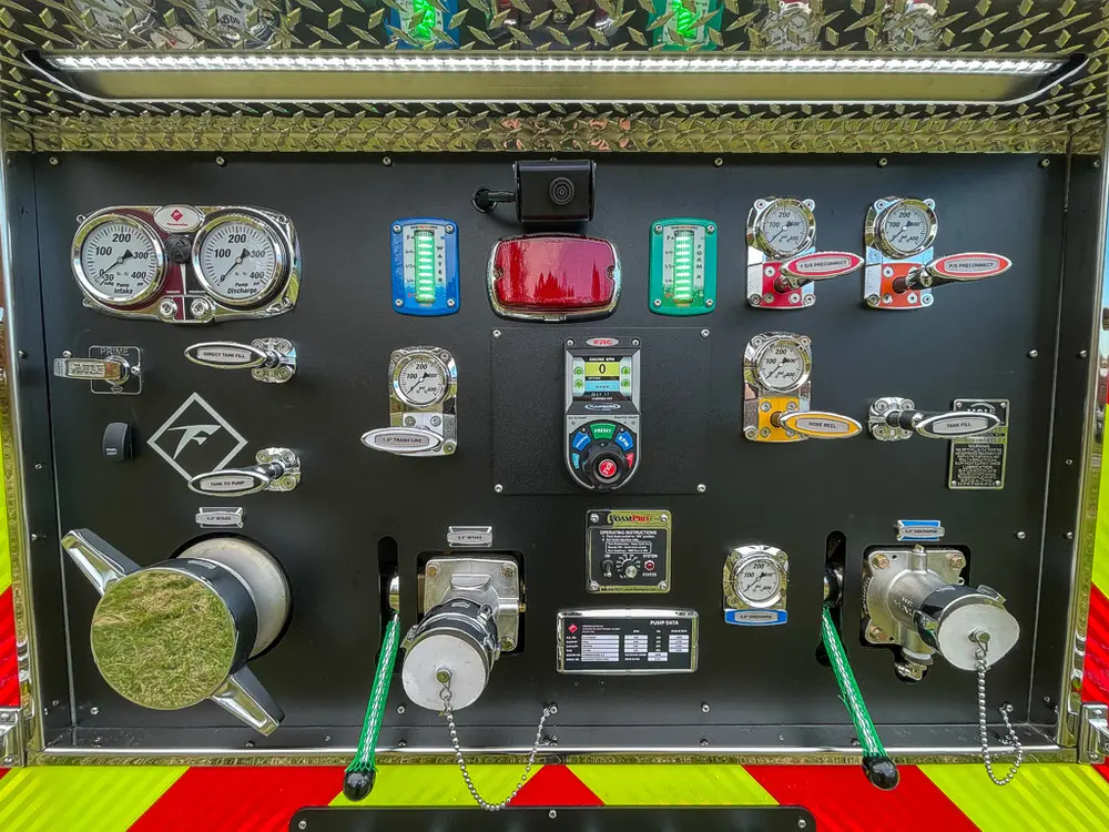 Close-up of rear pump control panel gauges and valves.