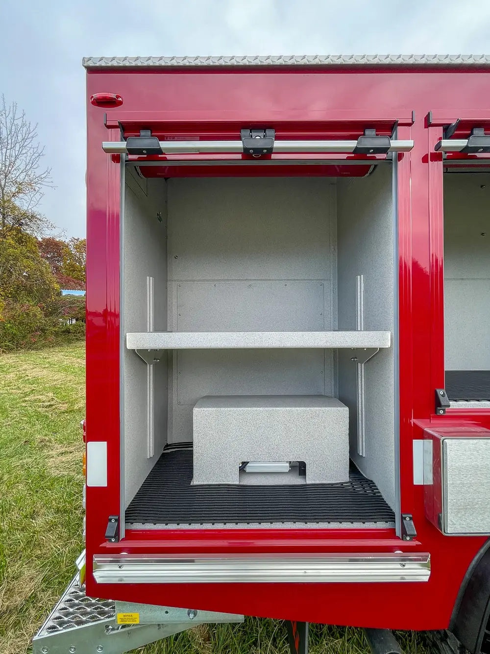 Open tall side compartment with shelves and lower storage box.