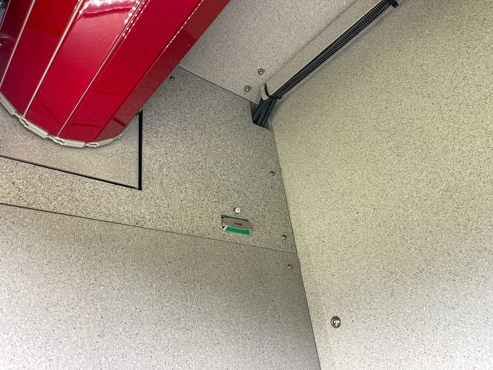 Upper interior corner of compartment with open roll-up door track.