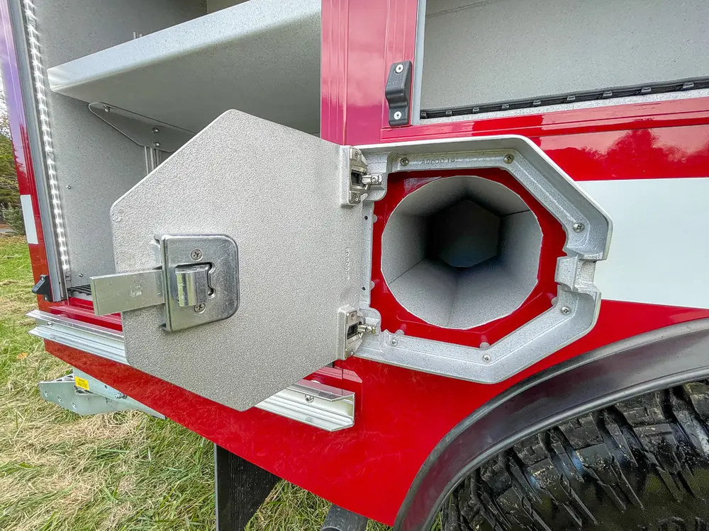 Open octagonal side intake port door on rear quarter panel.