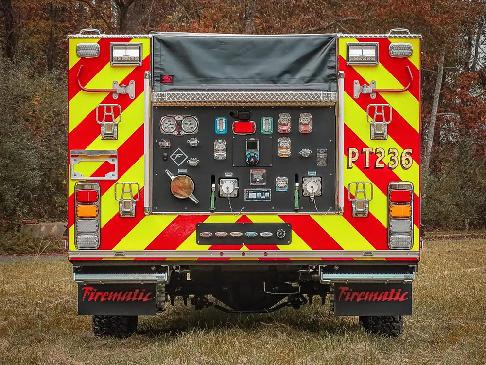 Straight rear view with open pump panel and chevron striping.