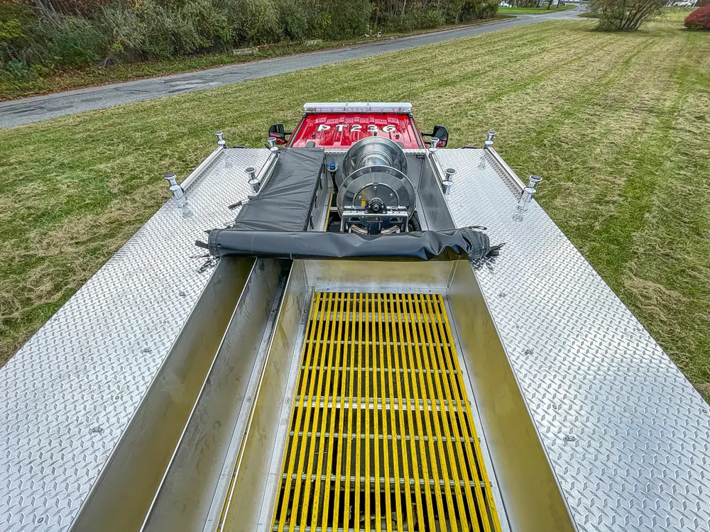 Rear deck top view with yellow center grate and hose reel.