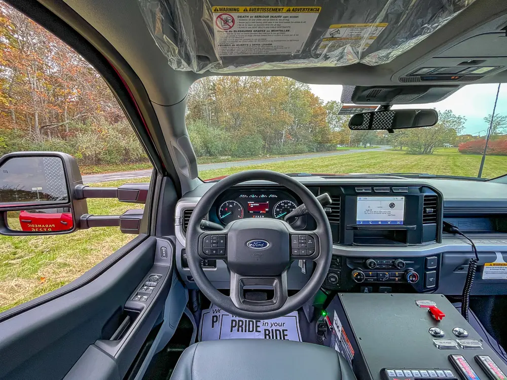 Cab interior wide view from center looking toward dashboard.