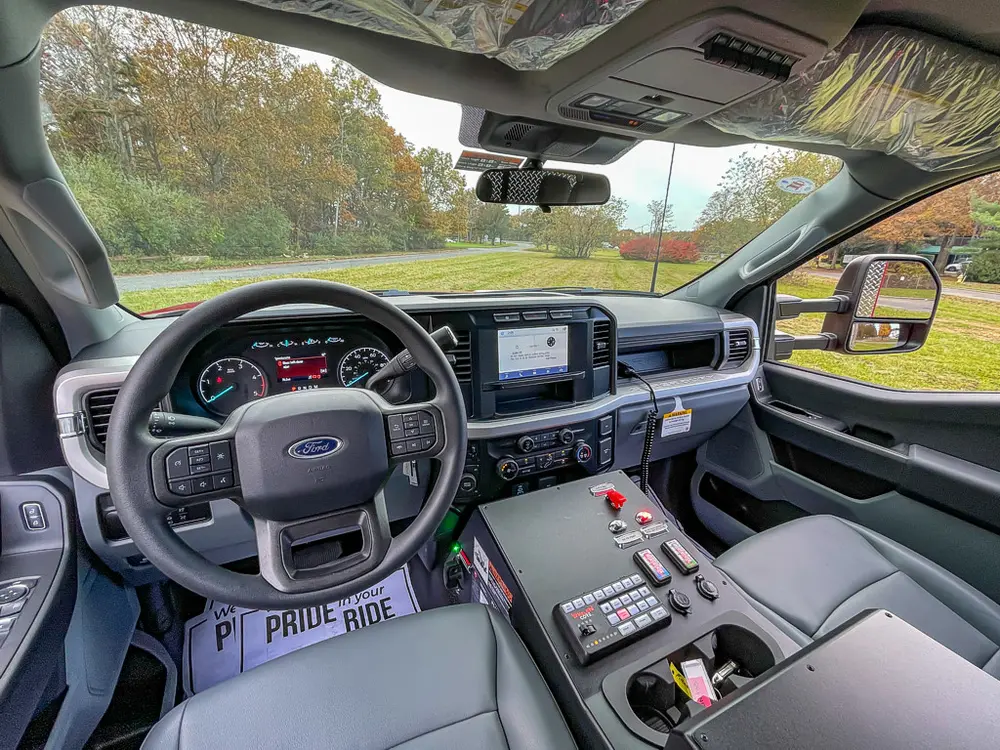 Front interior from passenger side showing steering wheel and console.