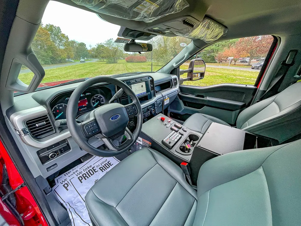 Driver-side cabin angle showing dashboard and center controls.