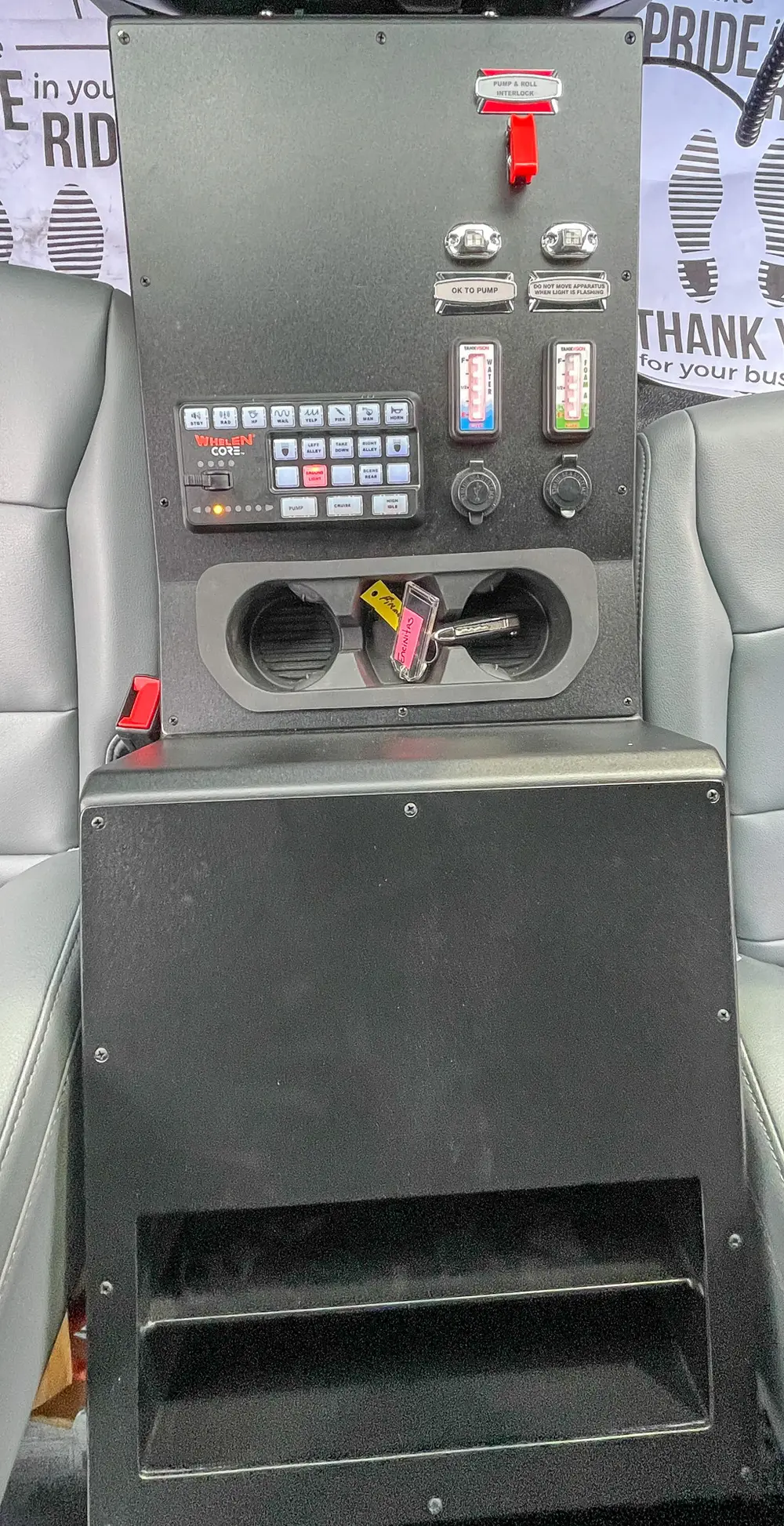 Rear of center console with open storage pocket and ports.