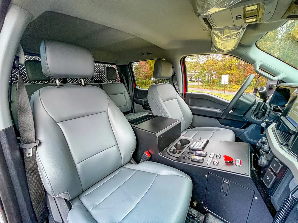 Front seats and center console viewed from rear passenger door.