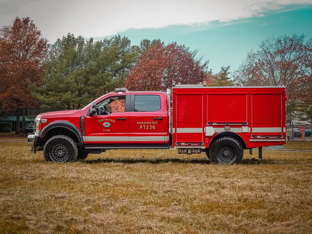 Full driver-side profile of truck parked on grass.