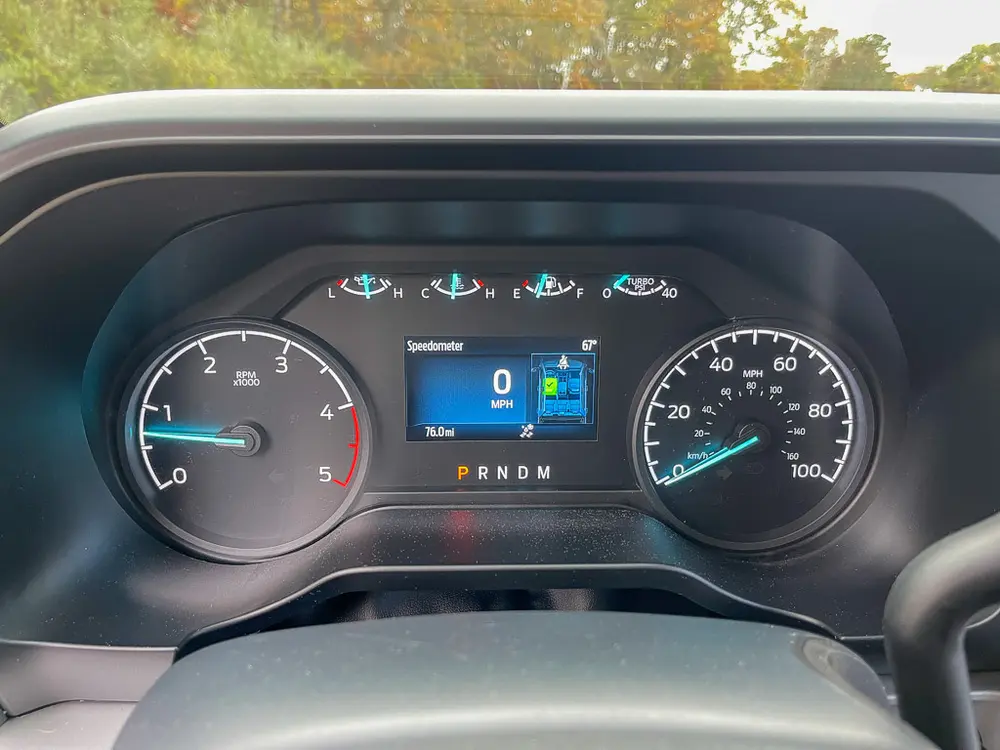 Instrument cluster with speedometer, tachometer, and digital display.