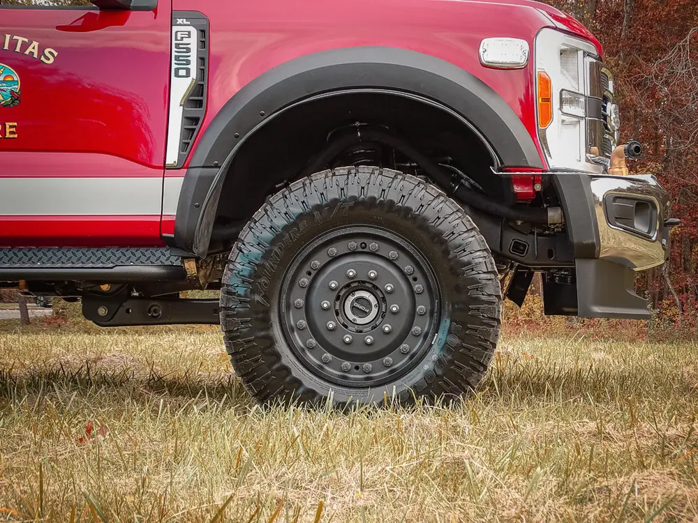 Passenger-side front wheel and suspension close-up.