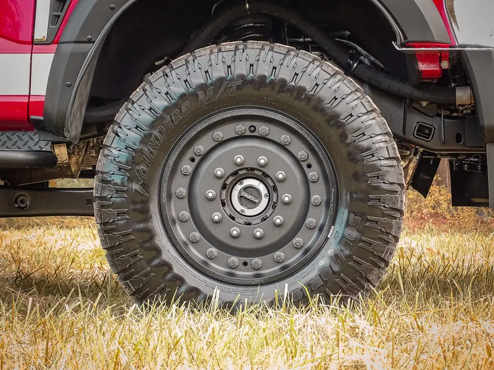 Close-up of rugged tire and steel wheel rim.