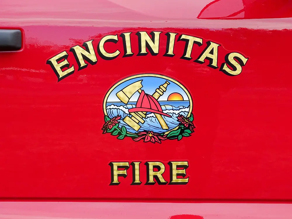 Encinitas Fire crest decal on red door panel.