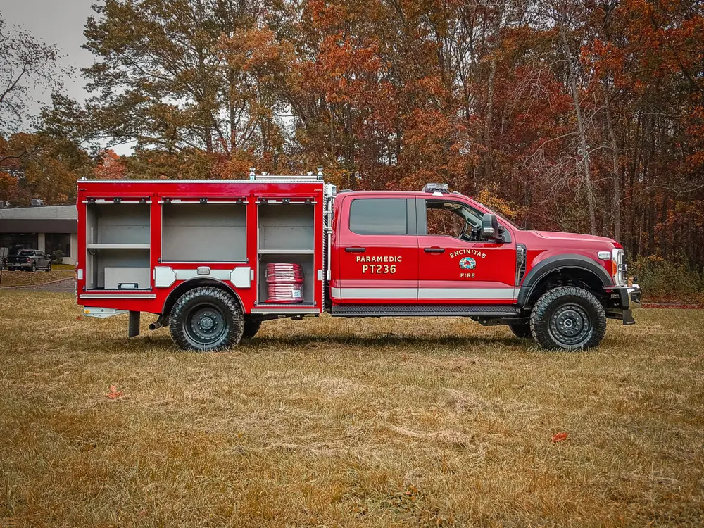 Passenger-side view with multiple compartment doors open.